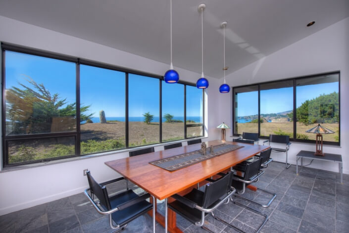 Sea Arches dining room table with view of ocean from Thomas Henthorne