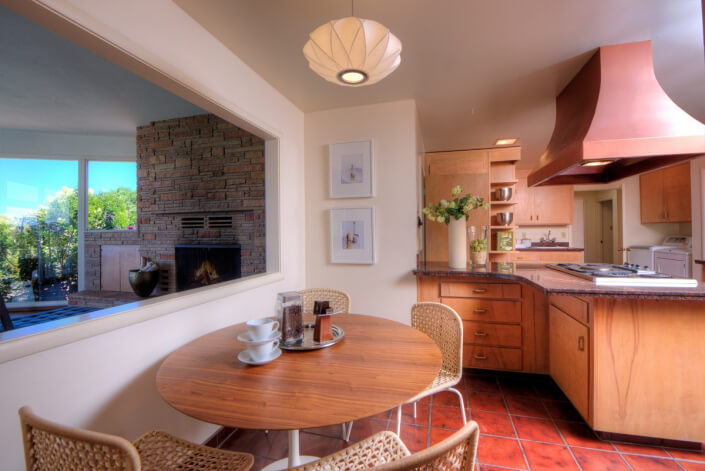 Kitchen with granite counters and hood over stovetop