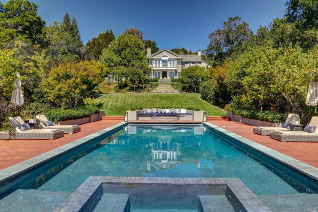 7 Bellagio Road Ross photo with pool in foreground and home in background on a sunny day