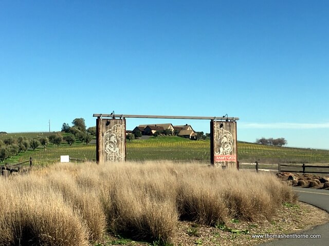 Entrance to Ram's Gate winery with large gate and building in background on a sunny day