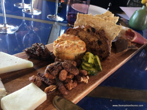 photo of the appetizer board with pickles and nuts and breads