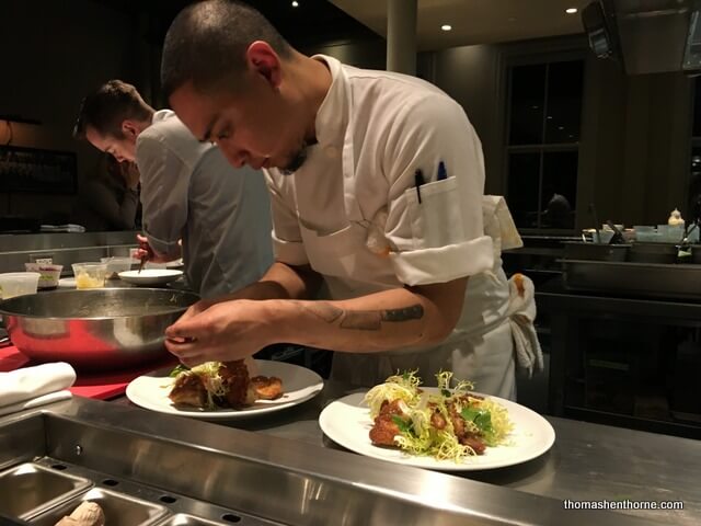 Photo of a sous chef plating food at The Commissary San Francisco