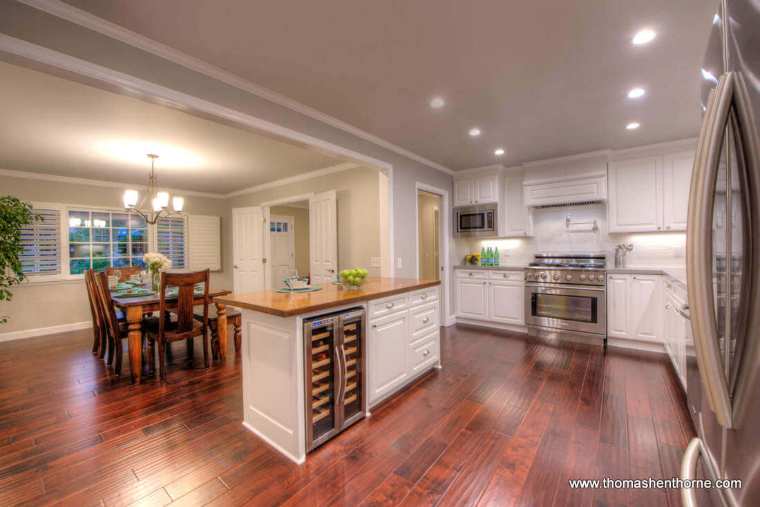 Open Kitchen With Wine Cooler and Stainless Appliances