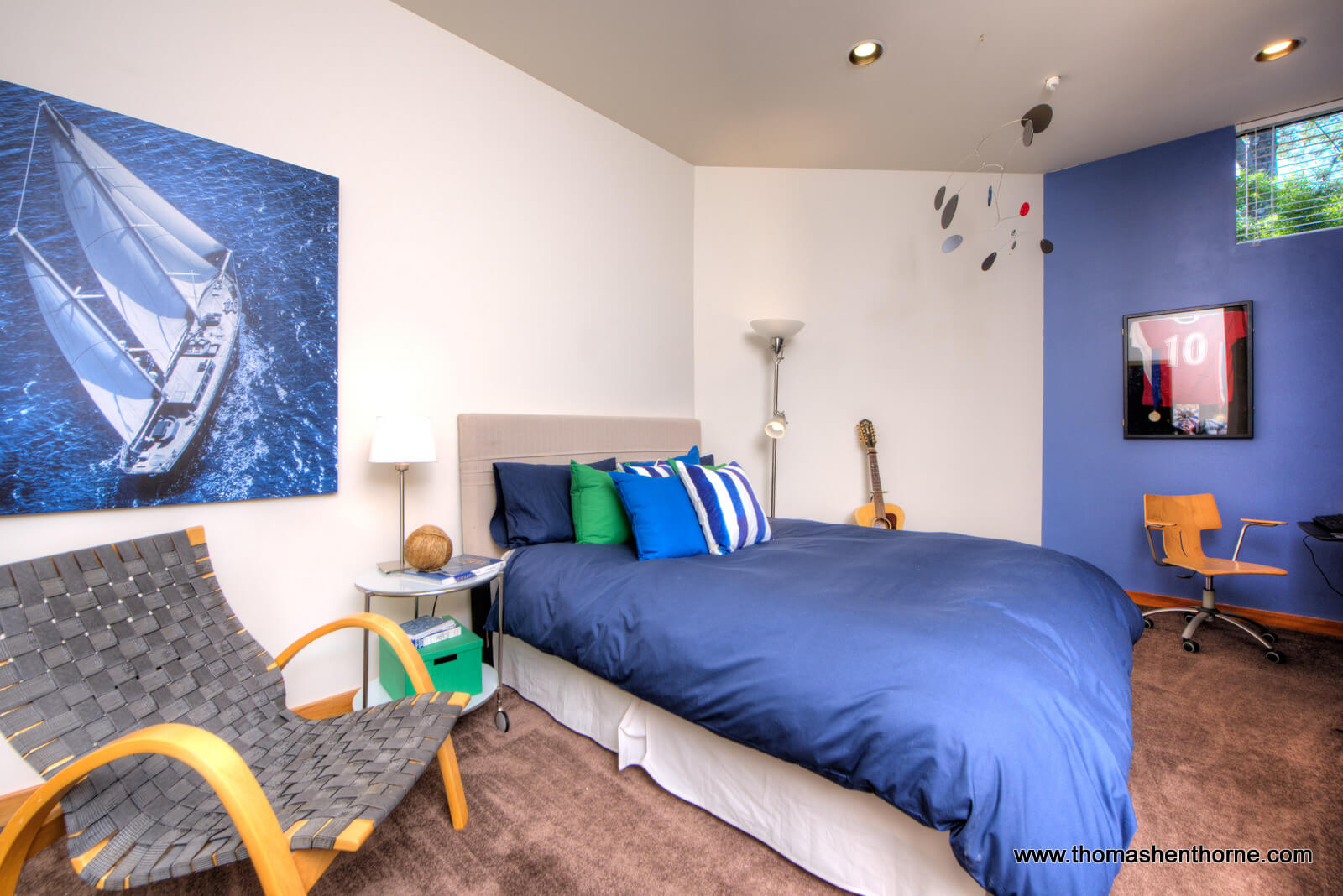 Guest room with blue walls and blue comforter