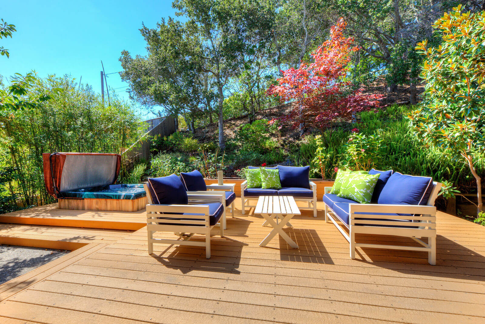 Deck seating area with hot tub in background