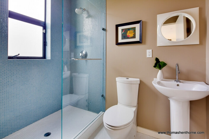 Bathroom with pedestal sink and mosaic tile