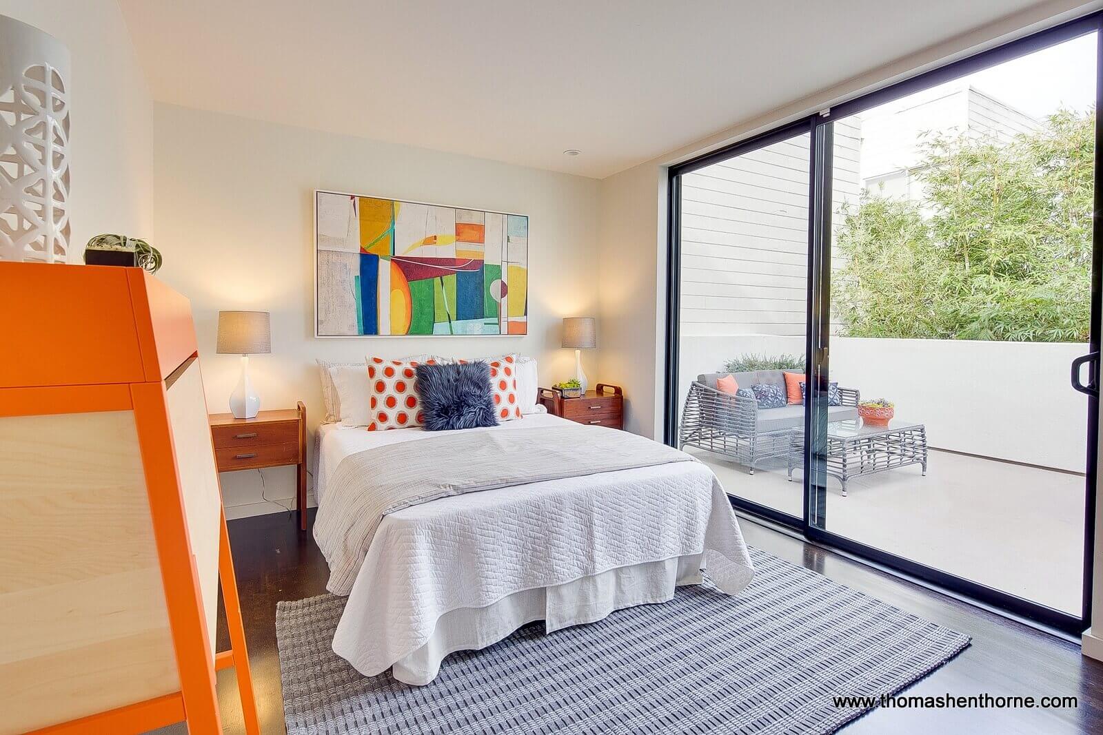 Guest bedroom at 124 Lily Place with glass sliding doors out to patio