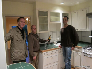 Jim Tyson and Michael Perona with Thomas Henthorne in the dated kitchen of their just-purchased home.