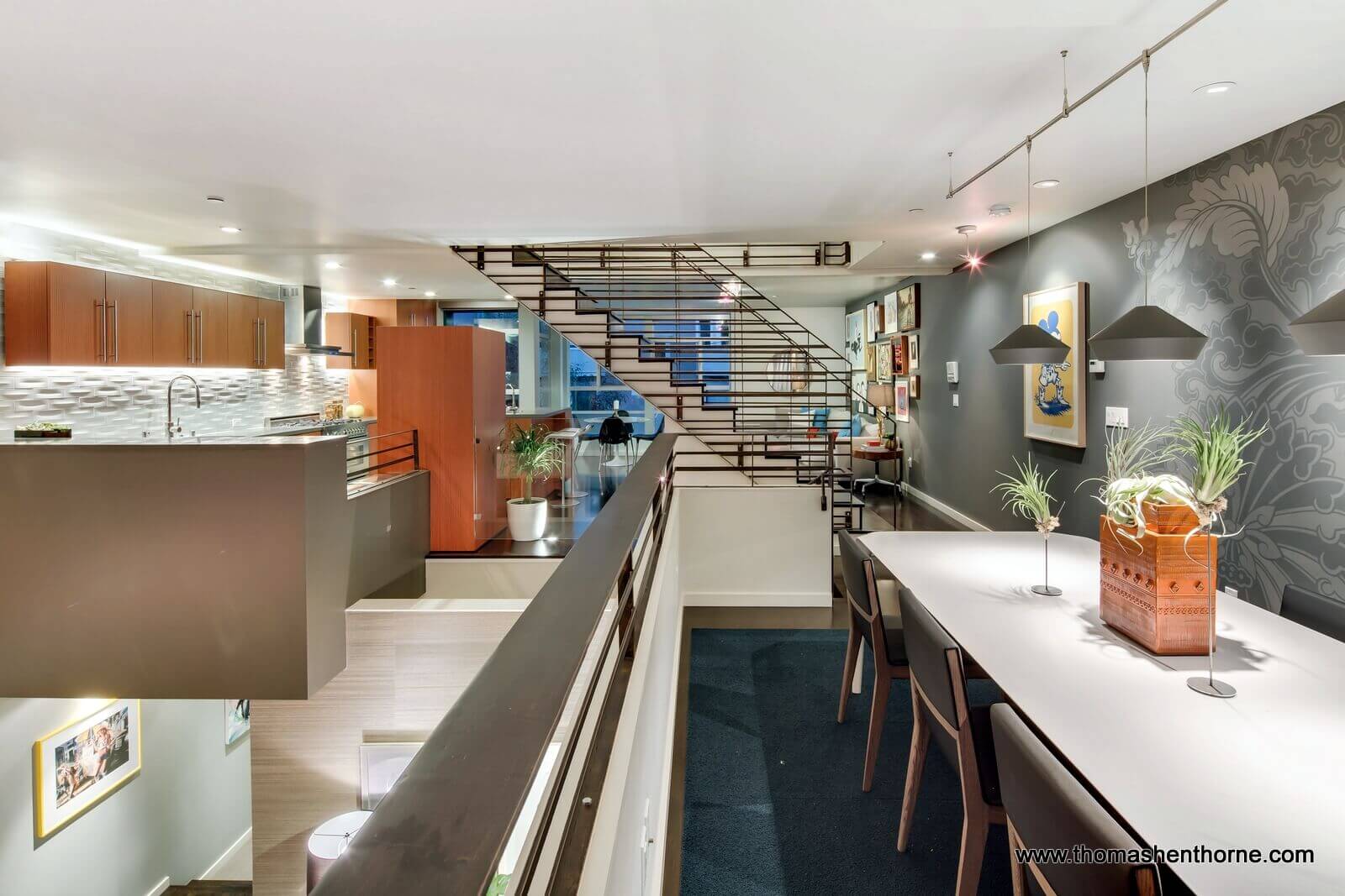 Mezzanine dining table with architectural stairway in background