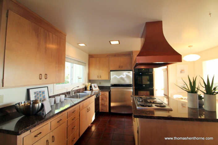 View of kitchen with copper colored hood