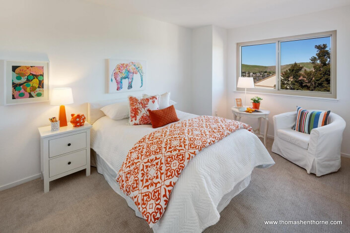 Bedroom with white and orange accents