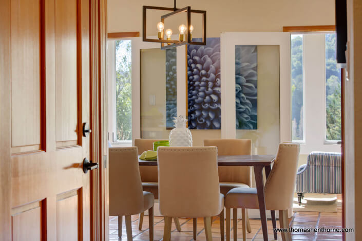 Dining table and chairs with modern light fixture