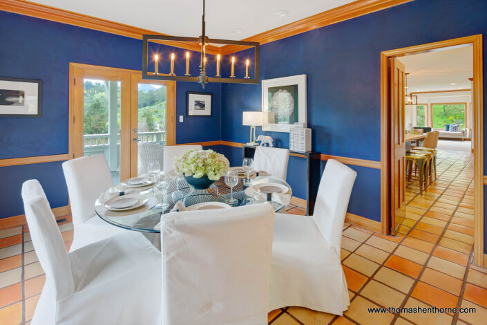 Dining room with round glass coffee table and blue walls