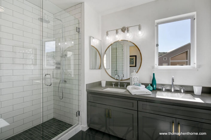 Modern master bathroom with dual vanity and glass shower