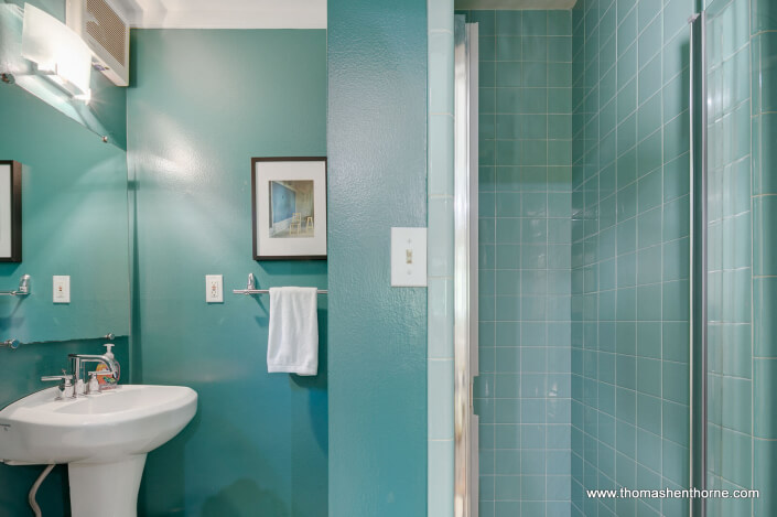 Pedestal sink and tiled stall shower