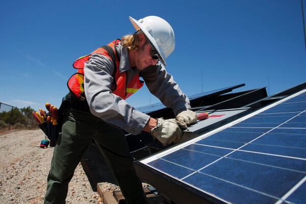 Man working on solar panels for solar lease article
