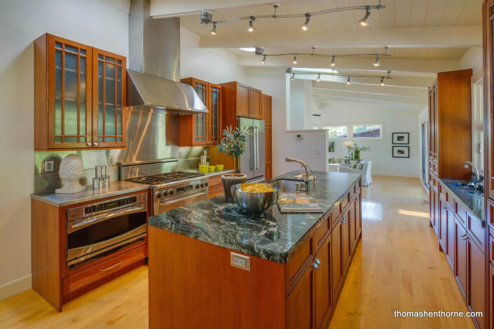 Modern kitchen with stainless appliances and stone countertops