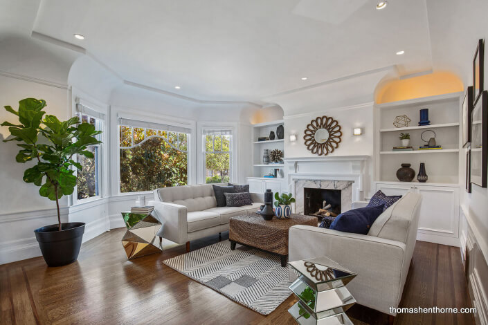 Living room with fireplace and bay window