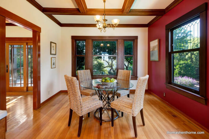 round glass table with leaded windows and coffered ceilings