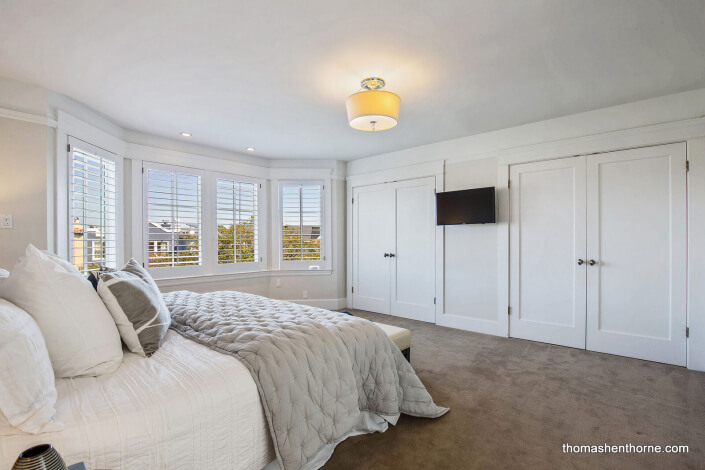 master bedroom with two closets and large windows