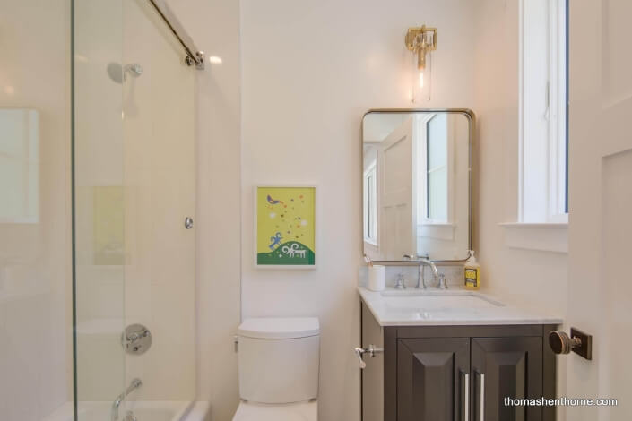 Bathroom with glass tub surround