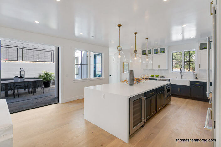 Kitchen opening onto patio with table and chairs