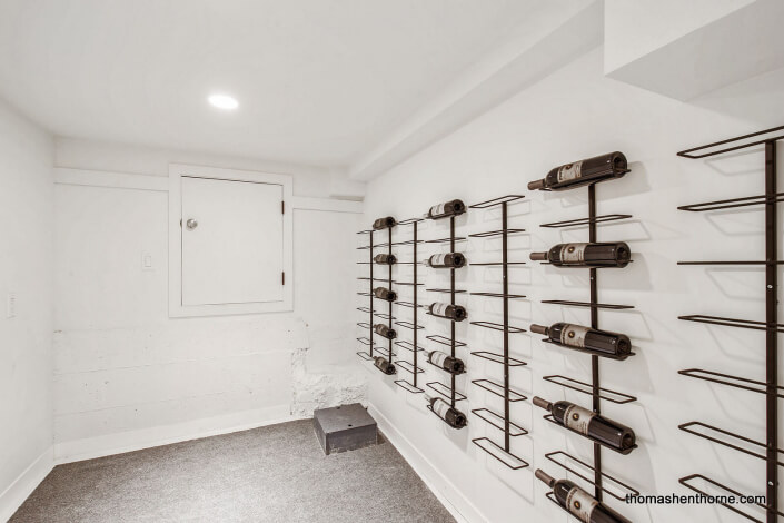 room with wine bottles on wall