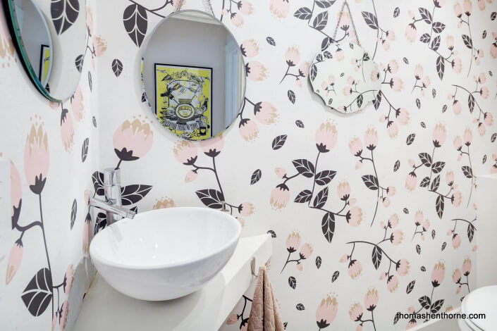 Half bathroom with floral wallpaper