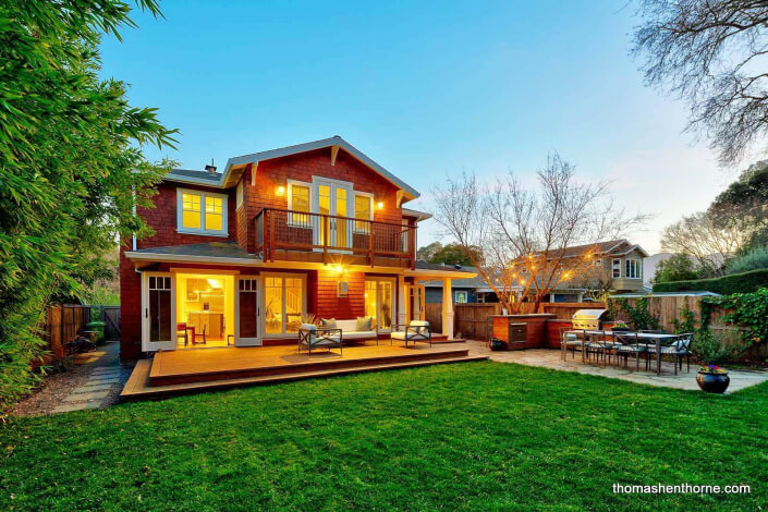 Craftsman home with large level lawn and outdoor dining table