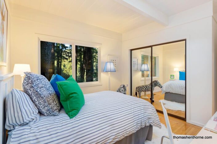 Bedroom with striped comforter on bed