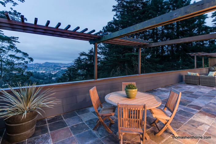 Outdoor tiled deck with view of bay