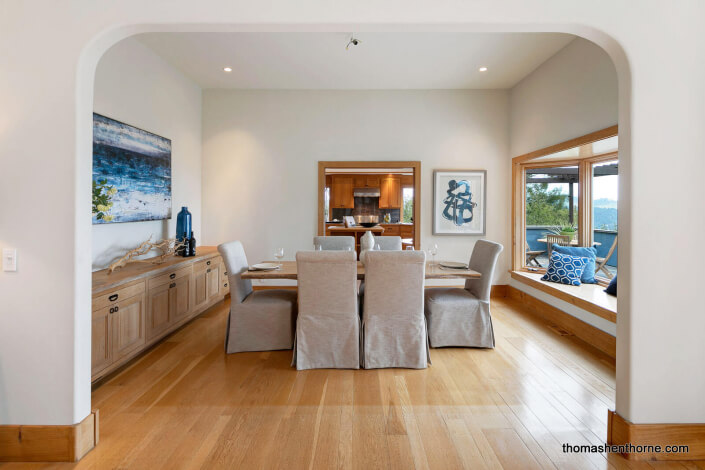 Dining room through arch with kitchen in distance