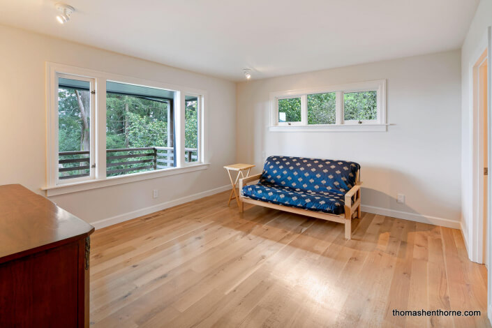 Room with wood floors and futon sofa