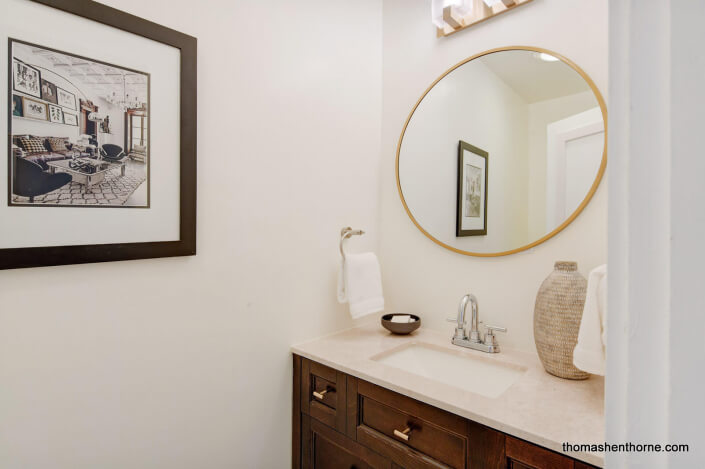 Powder room vanity with round mirror