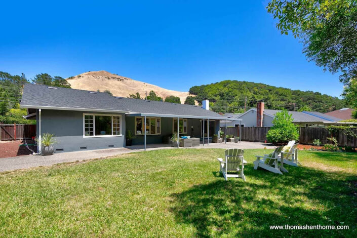 back yard with home and hills