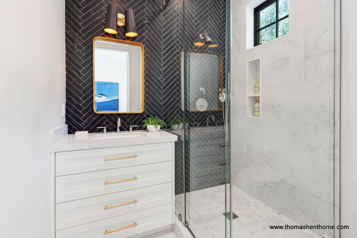 Bathroom with black herringbone tile with white grout