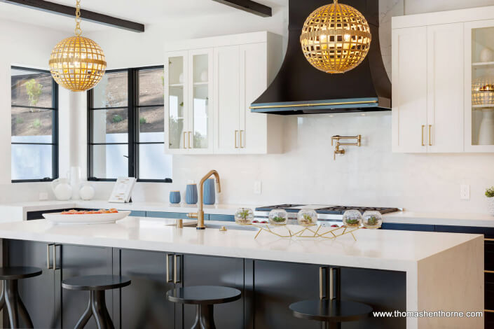 Marble kitchen island with 4 stools and two light fixtures above