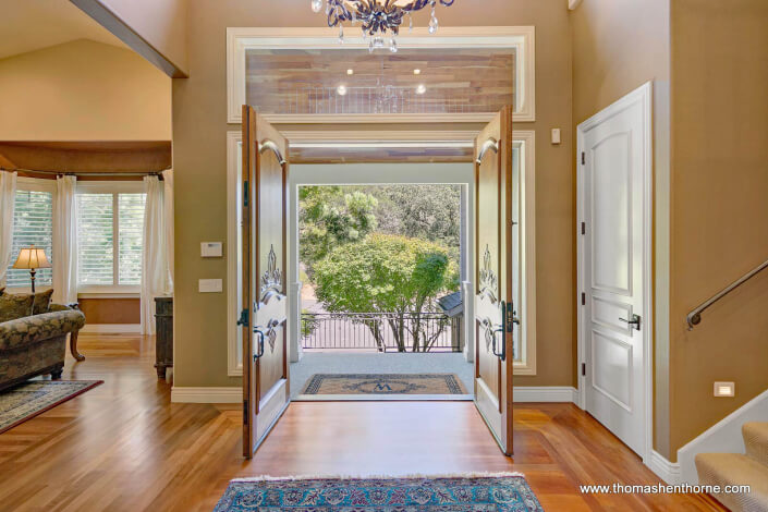 Entry foyer from inside home with two double doors