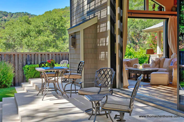 Home with open doors to concrete deck