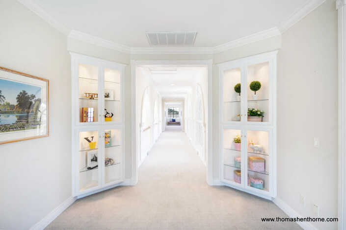 hallway with curio cabinets
