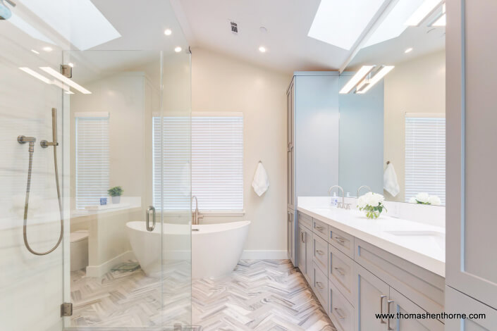 master bathroom with dual sinks and tile floor