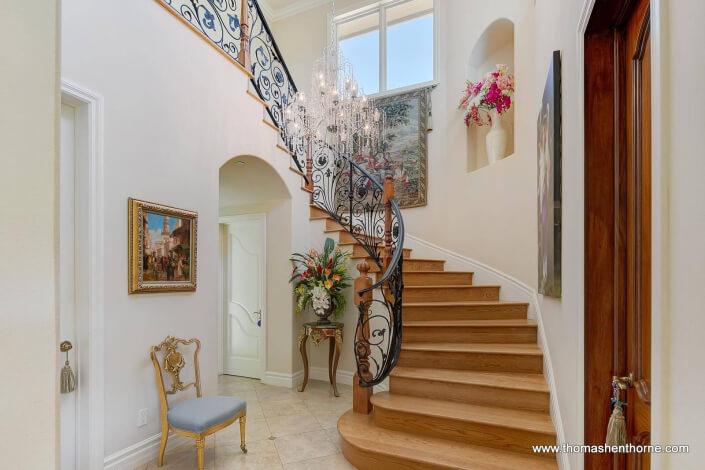 Graceful stairway with wrought iron railings