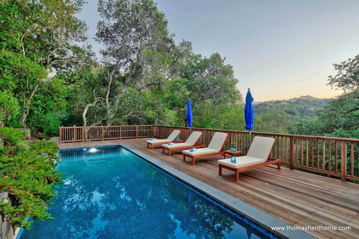 pool with four chaise lounges