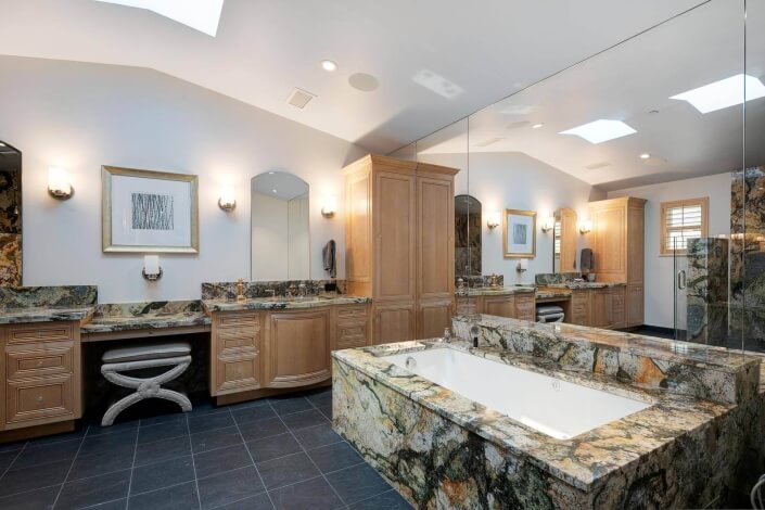 primary bathroom with soaking tub and dual sinks