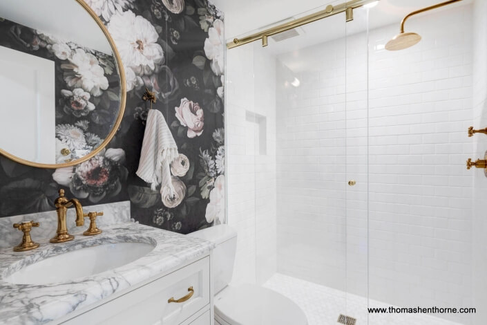 sink and shower tub with brass fixtures