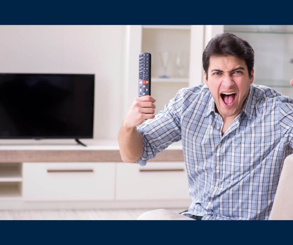 frsutrated man holding remote control photo