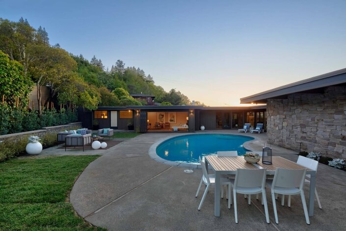 swimming pool and table and chairs and lawn