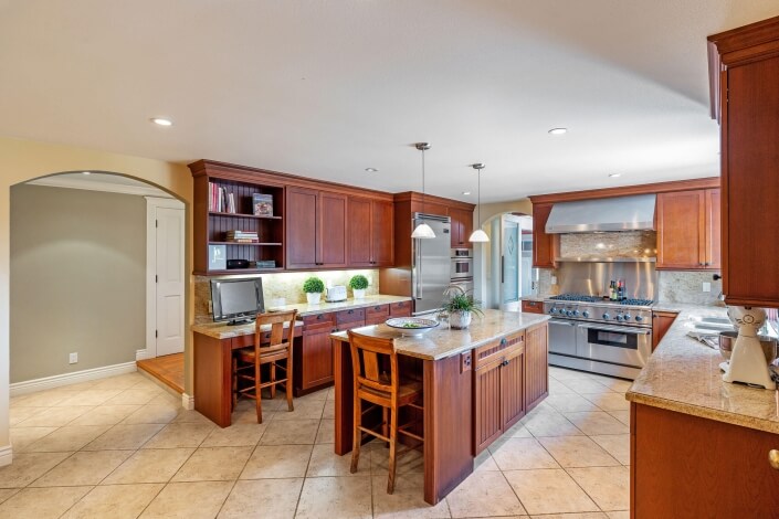 large kitchen with stone countertops