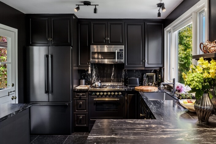 Modern kitchen with dark cabinetry and appliances