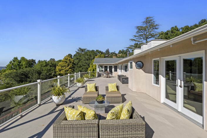 Outdoor large deck with sitting area and glass rails